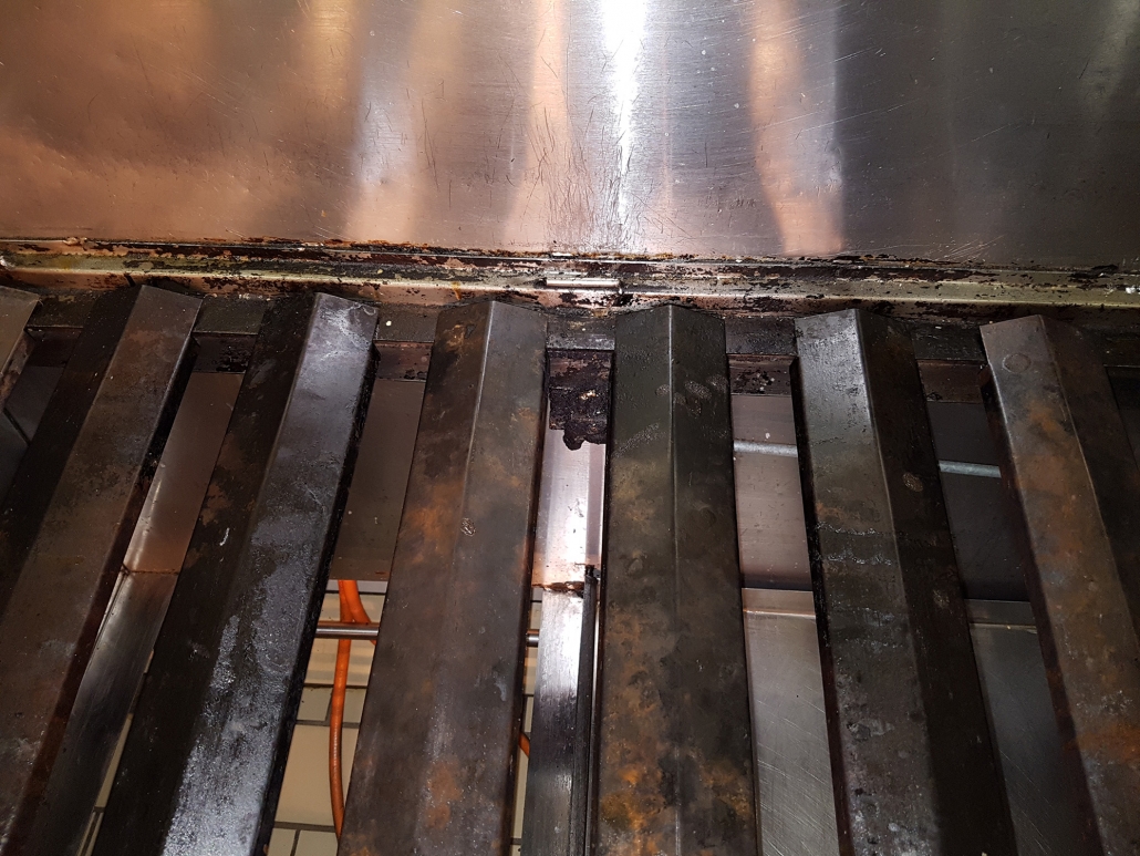 Kitchen extractor and grill bars caked in carbon and grease before cleaning