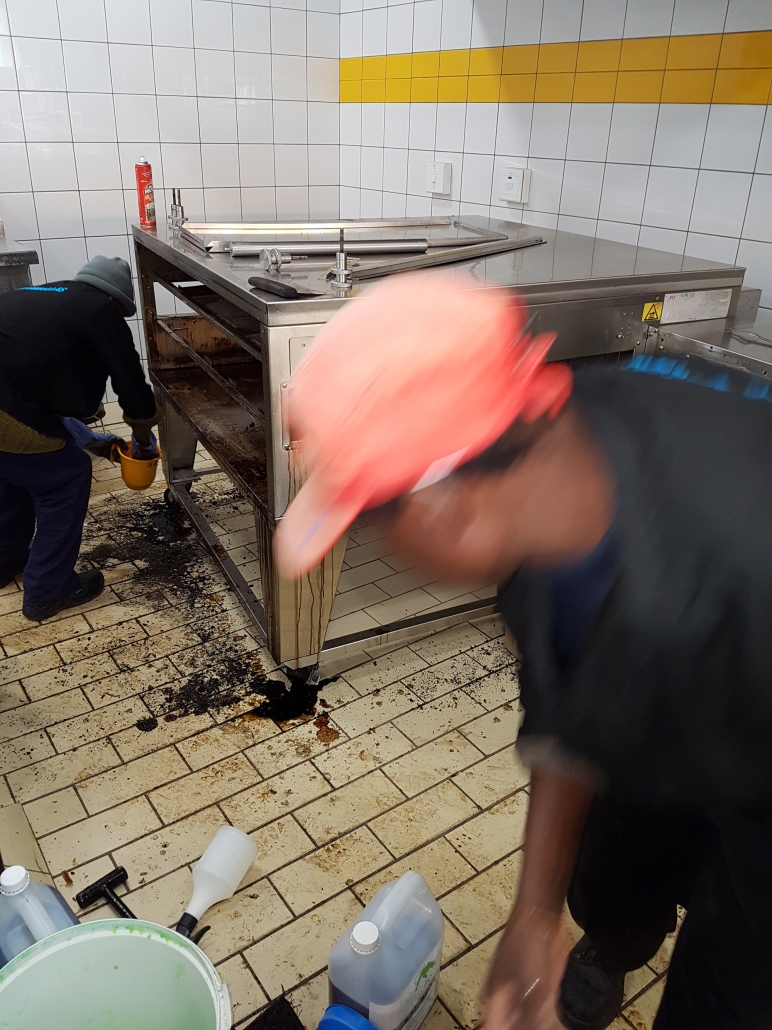 Cleanfellas team working on a commercial kitchen deep clean